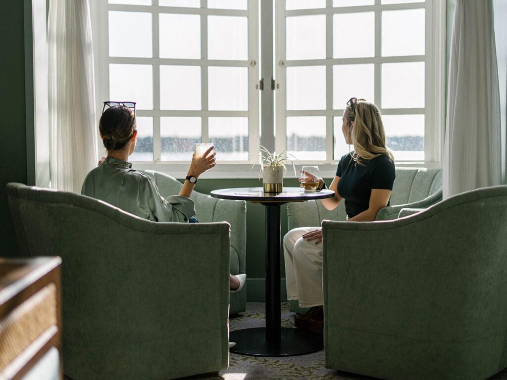 women drinking wine in hotel lobby