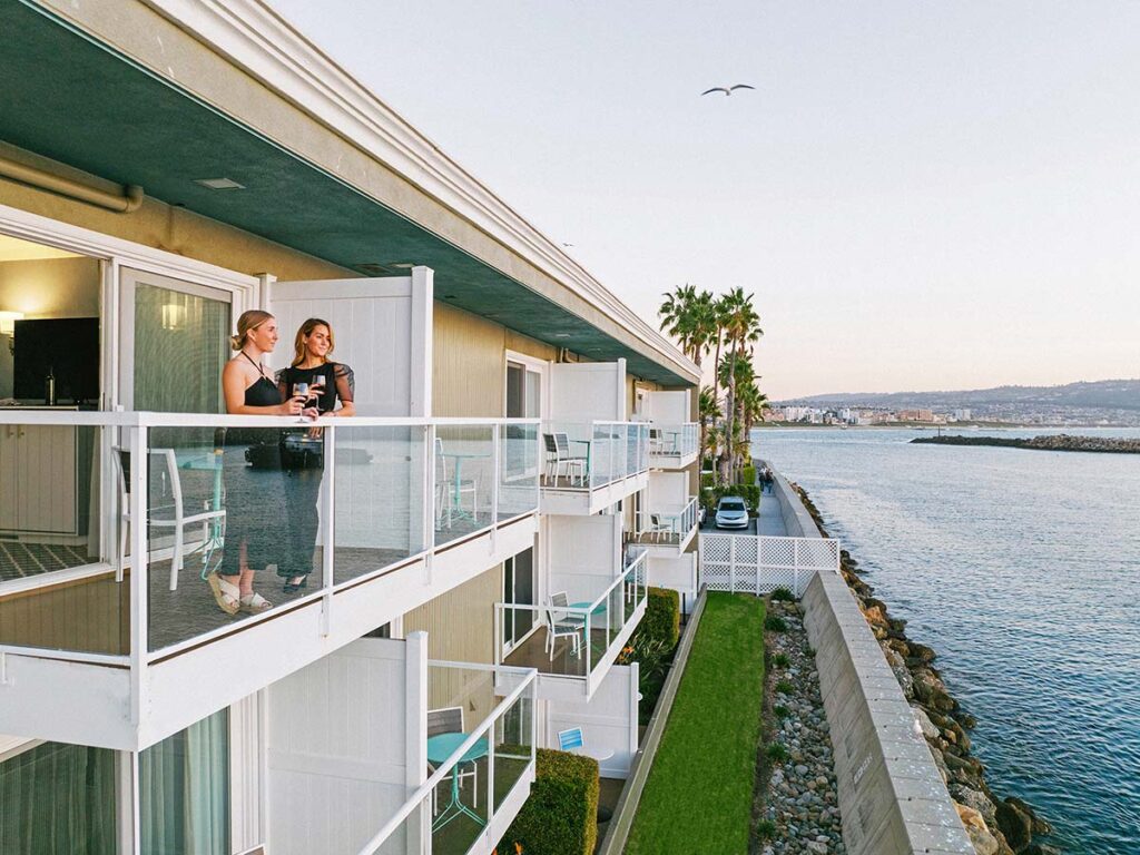 2 women on balcony drinking wine at Portofino Hotel